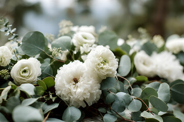 Close-up of a floral arrangement with white flowers and eucalyptus leaves.