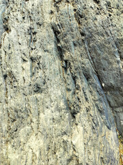 Textured stone background with rough rock wall surface, abstract natural grunge detail of stone material
