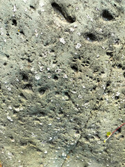 Textured stone background with rough rock wall surface, abstract natural grunge detail of stone material