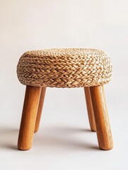 A charming woven seagrass stool with solid wood legs a perfect addition to bohemian home decor offering comfort and style for any room