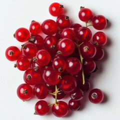 A vibrant cluster of ripe red currants showcases their juicy texture and intense color against a stark white background perfect for food blogs or culinary publications.