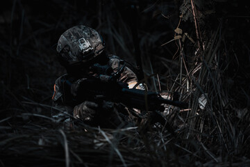 Army sniper during the military operation, dark process