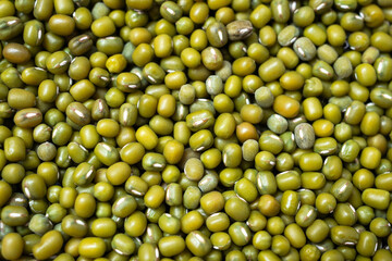 Dry organic moong whole dal or mung bean or green gram or maash top view background or texture. Healthy spices, nuts, seeds and herbal products.