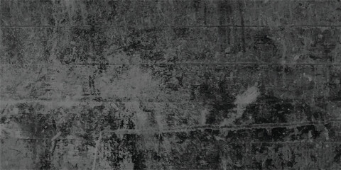 Weathered and distressed dark gray concrete wall texture showing a rough and aged surface with visible cracks and imperfections, ideal for backgrounds.