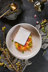 Mango avocado salmon tartare with gold accents, overhead photography, vibrant colors