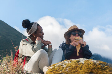 Tourists playing andean zampo&ntilde;a in the mountains