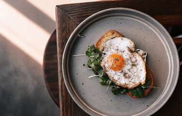 Overhead shot of breakfast with fried egg and toast on plate