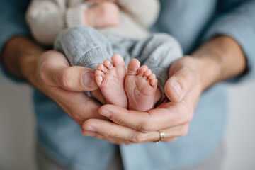 close-up photo of father holding babys tiny foot in his hand, emotional connection, soft natural light, 