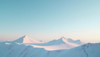 Serene Arctic Landscape: Snow-Covered Mountains Under a Pale Blue Sky at Dawn