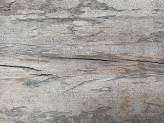 Cracked and Weathered Wood Surface. A close-up of cracked, weathered wood with natural grain...