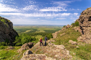 Fototapeta premium tourists men and women walk along the ridges of the Southern Urals on a summer day. Irendyk ridge