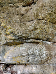 Textured stone background with rough rock wall surface, abstract natural grunge detail of stone material