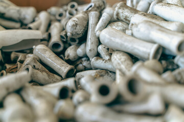 Abandoned industrial hall with old furniture, metal parts, and dusty workspaces. Atmospheric lost place showing decay, machinery remnants, and natural light through large windows.