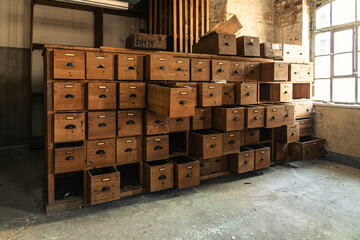 Abandoned industrial hall with old furniture, metal parts, and dusty workspaces. Atmospheric lost...