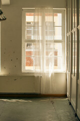 Abandoned industrial hall with old furniture, metal parts, and dusty workspaces. Atmospheric lost...
