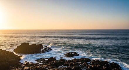 Ocean Waves Crashing on Rocky Shoreline Under Golden Sunlight at Sunset