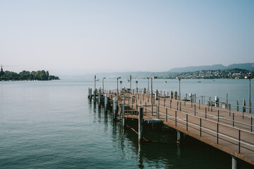 Obraz premium Empty lake pier stretching out to sea.