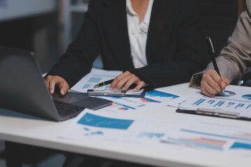 Close up of Business team analyzing income charts and graphs with modern laptop computer. Business analysis and strategy concept.