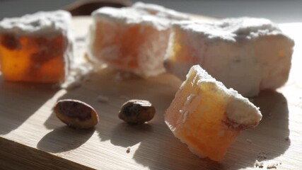 Soft loukumi cubes with pistachios in sunlight, traditional Cyprus Turkish delight