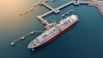 Aerial view of an LNG tanker docked at an offshore terminal with multiple pipelines, storage tanks,...