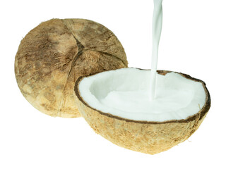 Fresh coconut milk being poured into a halved coconut shell, isolated on white background. Concept of tropical cuisine, plant-based milk, and organic food ingredients.