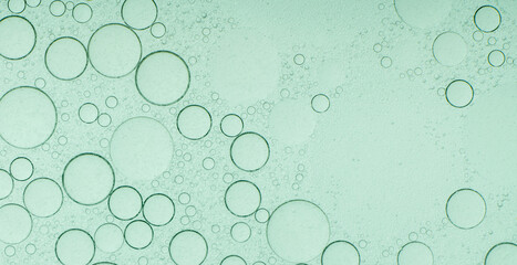 Macro microscope green bubble texture, Close-up Green bubbles and drops oil background . blue green water bubbles, close up golden oil drop for cosmetic