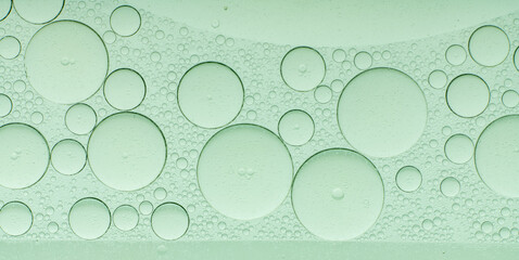Macro microscope green bubble texture, Close-up Green bubbles and drops oil background . blue green water bubbles, close up golden oil drop for cosmetic