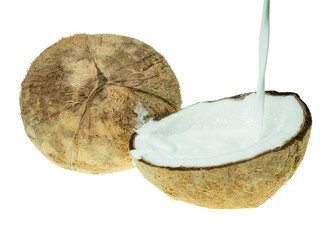 Fresh coconut milk being poured into a halved coconut shell, isolated on white background. Concept of tropical cuisine, plant-based milk, and organic food ingredients.