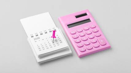 Calendar 2026 with pinned date and pink calculator on light grey background, business financial reminder, budget planning