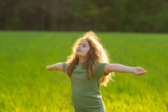 Freedom of dreaming child. Kid enjoying carefree summer day. Kid meditation in nature. Dreams of childhood. Peaceful child portrait. Kids peace and happiness. Nature harmony. Mind and calm kid.
