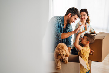 New home, box and parents with child in new house, property mortgage and real estate investment.