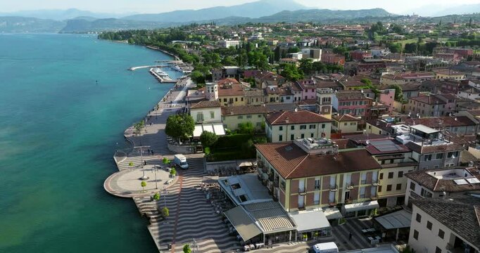 Aerial View Of Lakeside Town Of Lazise On Shore Of Lake Garda In Province of Verona, Italy. orbiting shot