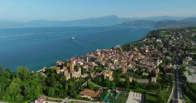 Lakeside Village Of Lazise By The Lake Garda With Calm Blue Water In Summer In Italy. - arrial shot