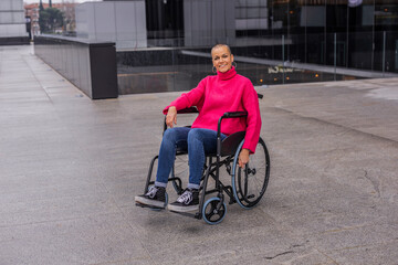 Happy disabled businesswoman smiling in wheelchair outside office building