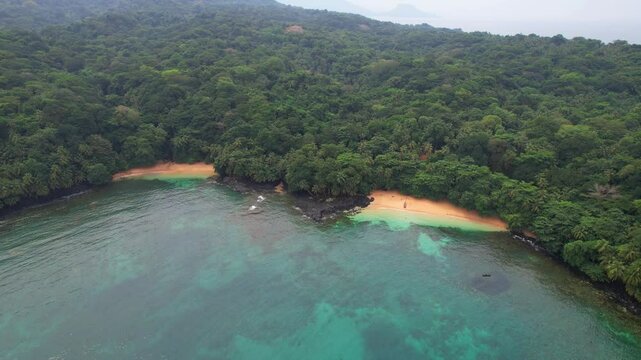 Flying backwards with the wonderful green forest and the beautiful Margarida beach in Ilha do Principe (Prince Island) S&atilde;o tom&eacute;,Africa