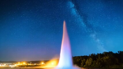 Spectacular geyser erupts at night under a starry sky, illuminating the landscape with ethereal light and a backdrop of stars, astrophotography - Powered by Adobe