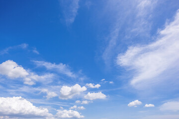 Obraz premium clear blue sky background,clouds with background, Blue sky background with tiny clouds. White fluffy clouds in the blue sky. 