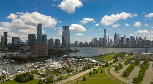 Manhattan aerial skyline, New York. Panorama view of New York city skyscrapers on blue sky. USA NYC. Lower NYC skyline on sunny day. New York cityscape. New York City with clouds from drone.