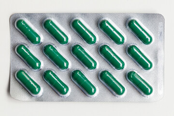 Blister pack containing green capsules commonly used for medications