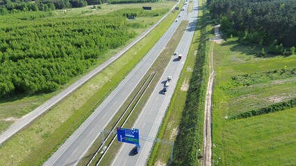 Aerial scene of cars on forest highway