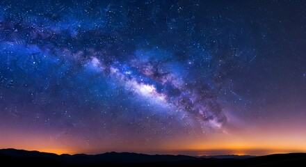 Fototapeta premium Long-Exposure Wide-Angle Night Sky with Diagonal Milky Way, Color Gradient from Indigo to Orange, Dense Stars, and Silhouetted Mountain Horizon