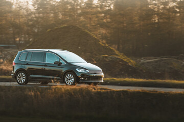 Minivan commuting on street with traffic