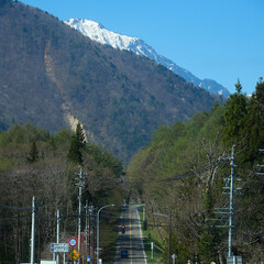 春の観光名所長野県の大町アルペンラインの農家と立山連峰の雪景色
