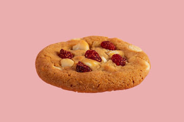 Vanilla cookies topped with nuts and strawberries on a pink background