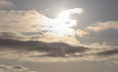 The sky is cloudy and the sun is shining through the clouds