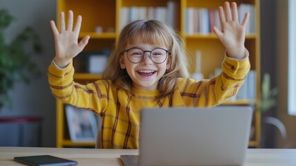 Child enthusiastically waves hello during an online session at home using a laptop