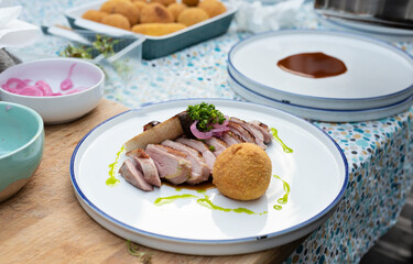 Gourmet food. A piece of grilled meat with mushroom and sauce on white plate in restaurant. Fresh...