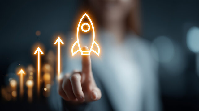 A businesswoman's finger touches a glowing holographic rocket surrounded by upward arrows, symbolizing startup launch, rapid growth and innovative success in today's digital environment               
