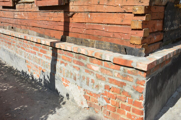 Foundation Repair Renovation. Old wooden house with  brick foundation repair renovation.