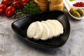 Organic mozzarella cheese slices in the plate